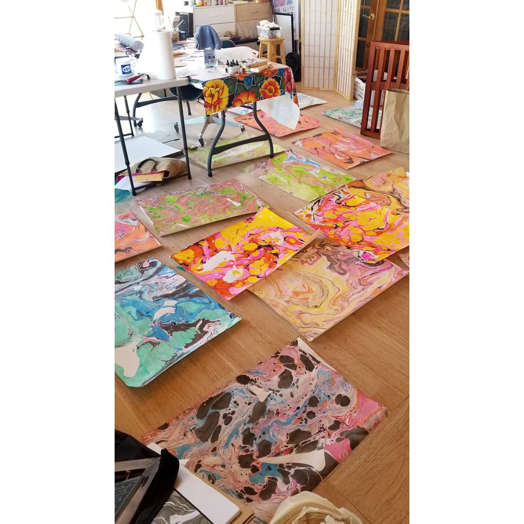 20 large marbled prints on a studio floor