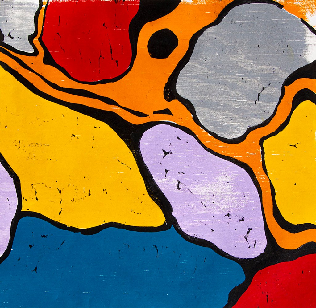 brightly colored jigsaw print, reds, light violet, yellow, blue, & gray